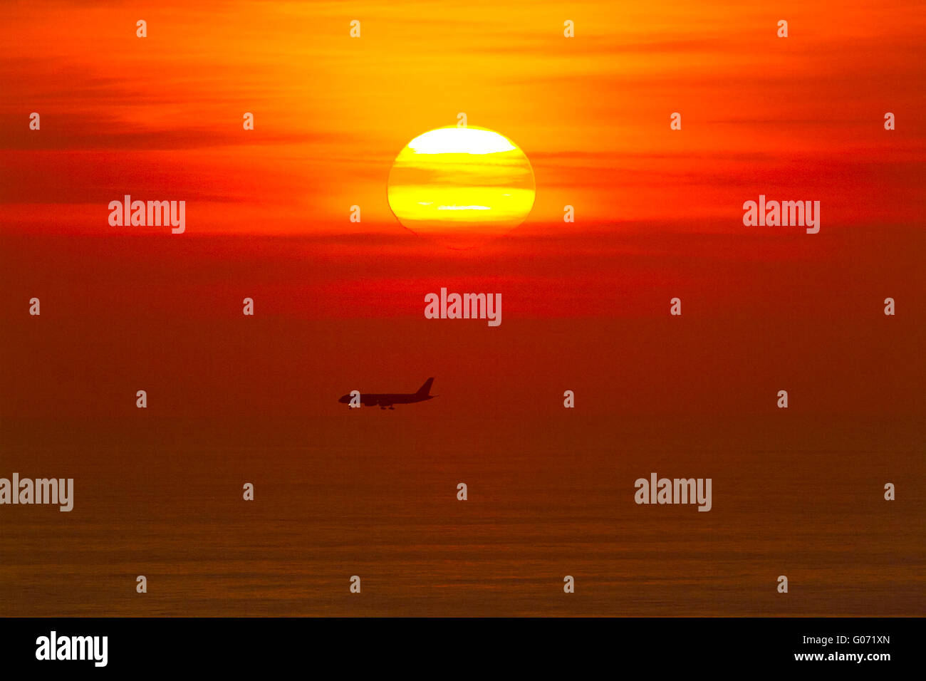 London UK. 29th April 2016. A passenger jet prepares to land over the Mediterranaean sea during a colorful sunset Credit:  amer ghazzal/Alamy Live News Stock Photo