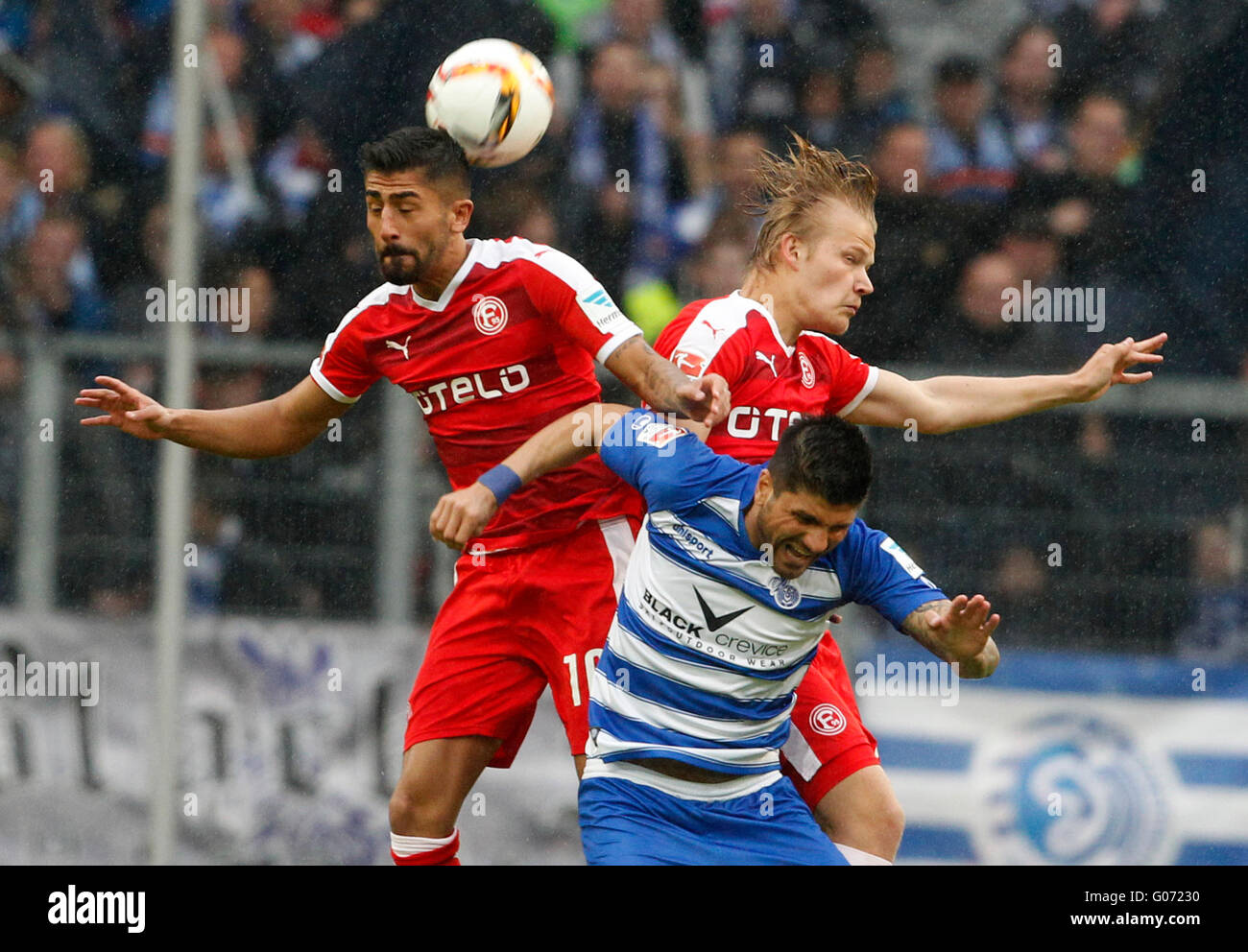 Duisburg's Baris Ozbek (C) and Duesseldorf's Kerem Demirbay (L) and Joel Pohjanpalo vie for the ball during the German Bundesliga soccer match between MSV Duisburg and Fortuna Duesseldorf in the Schauinsland Reisen Arena in Duisburg, Germany, 29 April 2016. Photo: ROLAND WEIHRAUCH/dpa (EMBARGO CONDITIONS - ATTENTION - Due to the accreditation guidelines, the DFL only permits the publication and utilisation of up to 15 pictures per match on the internet and in online media during the match) Stock Photo