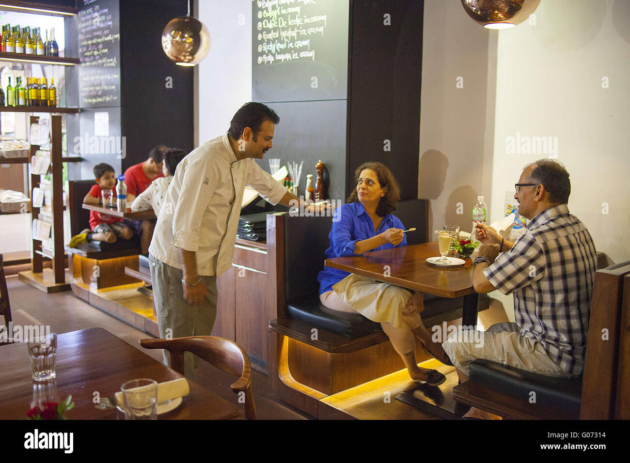April 19, 2016 - Mumbai, Maharashtra, India - 19 April 2016 - Mumbai - INDIA..Chef Paramjeet Singh talks with Patrons at the Indigo Restaurant at Inorbit Mall in Mumbai..The restaurant scene in India is rapidly developing. New restaurants are constantly opening as businesses try to capitalise on the countryÃ•s rising wealth and a burgeoning young and better-travelled population. India has long been dominated by unbranded eateries, mainly serving North Indian and South Indian food. But there is an ever-growing appetite  for the big-name chains and both international and home-grown cafes and hip Stock Photo