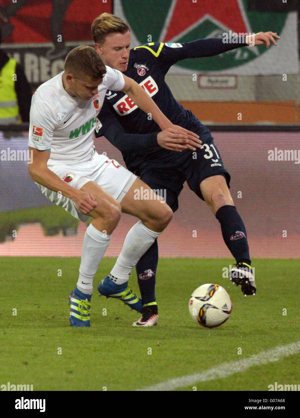 Augsburg's Alfred Finnbogason (l) and Cologne's Yannick Gerhardt in action during the German Bundesliga soccer match between FC Augsburg and 1. FC Cologne at WWK-Arena in Augsburg, Germany, 29 April 2016. PHOTO: STEFAN PUCHNER/dpa Stock Photo