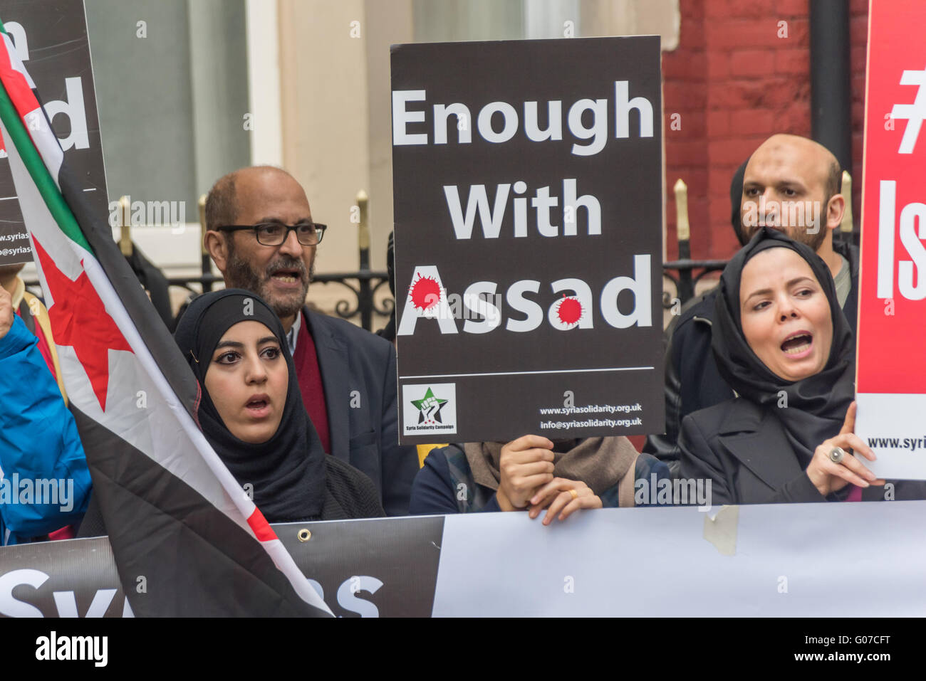 London, UK. 30th April, 2016. Protesters close to the Russian Embassy were calling for an end to Russian and Syrian air strikes on Aleppo after a raid on the Al-Qudus hospital there last Wednesday night killed tens of civilians including children and three doctors. Enough with Assad states a poster at the protest.  Peter Marshall/Alamy Live News Stock Photo