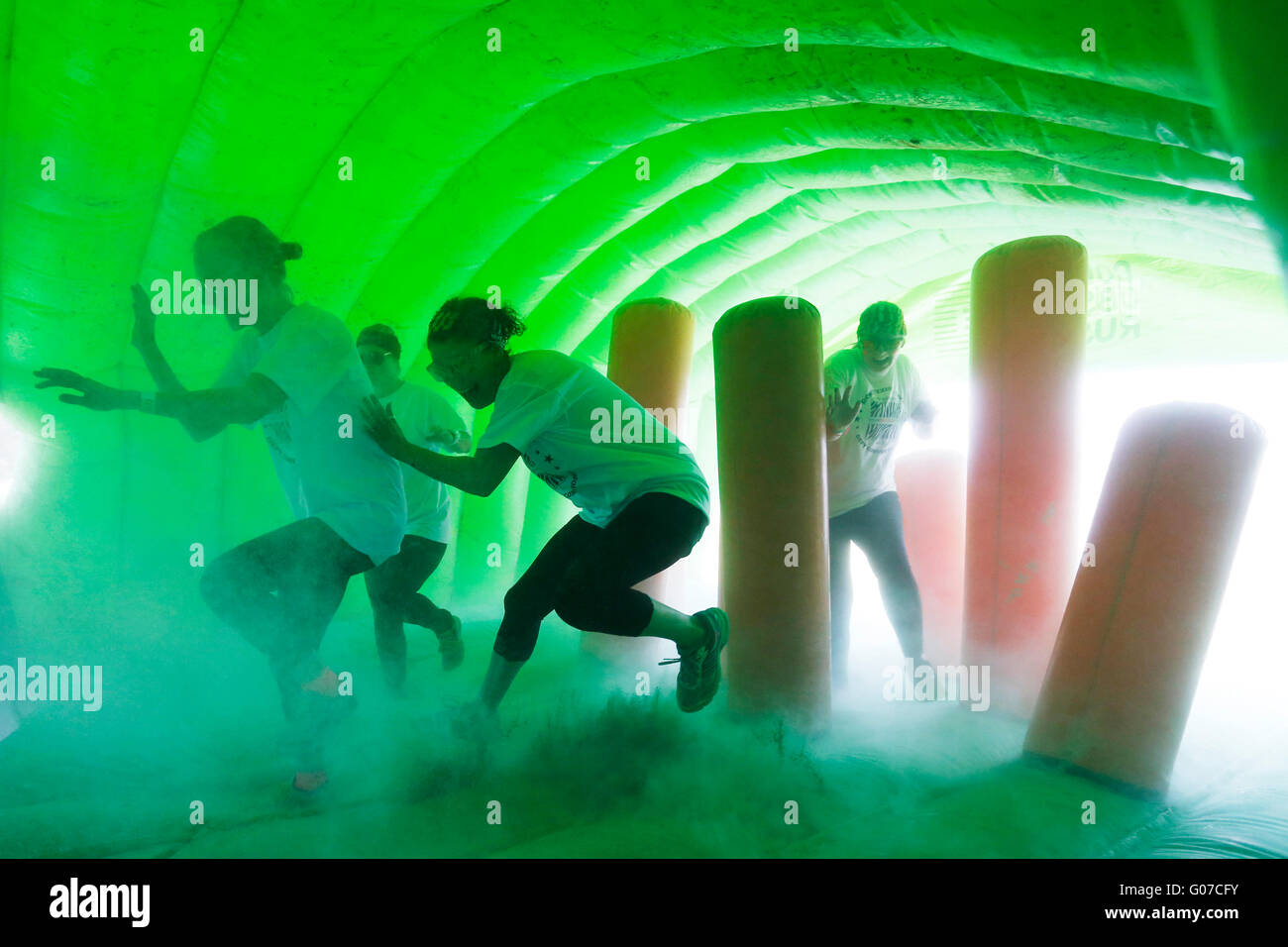 Brighton, UK. 30th Apr, 2016. Participants compete in the 'Color Obstacle Rush' during sunny Bank Holiday weather in Brighton, UK, Saturday April 30, 2016.  Competitors are showered with coloured powder as they try to complete an inflatable obstacle course. Credit:  Luke MacGregor/Alamy Live News Stock Photo