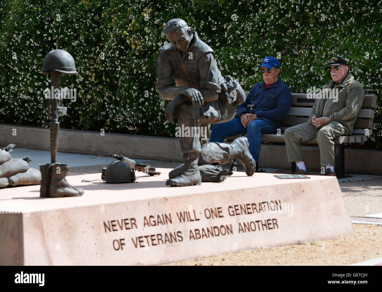 Albuquerque, NM, USA. 30th Apr, 2016. left to right Dee Friesen (USAF 69-70) and Lowell Little (USAF-70-) share a bench as they look towards the statue commemorating the Vietnam War where they both served. This bronze monument depicts a soldier saying goodbye to his buddy. The Field Cross is made using a helmet, a rifle, and a pair of boots, and is a stark reminder of the loss of his friend. The artist is George Salas, a Vietnam Veteran.Saturday, April. 30, 2016. © Jim Thompson/Albuquerque Journal/ZUMA Wire/Alamy Live News Stock Photo
