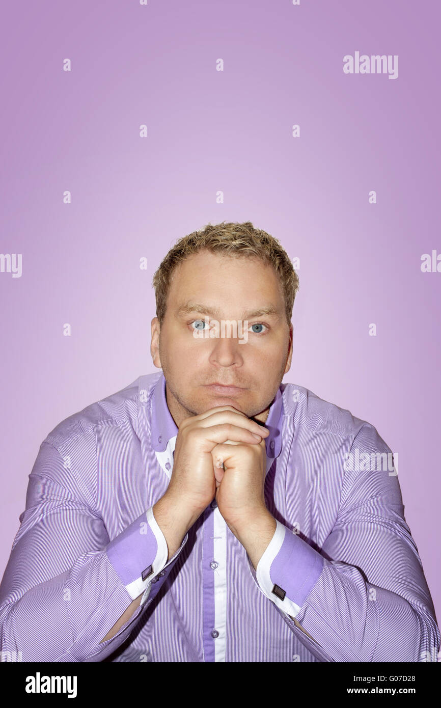 Man dressed in purple shirt on purple background Stock Photo