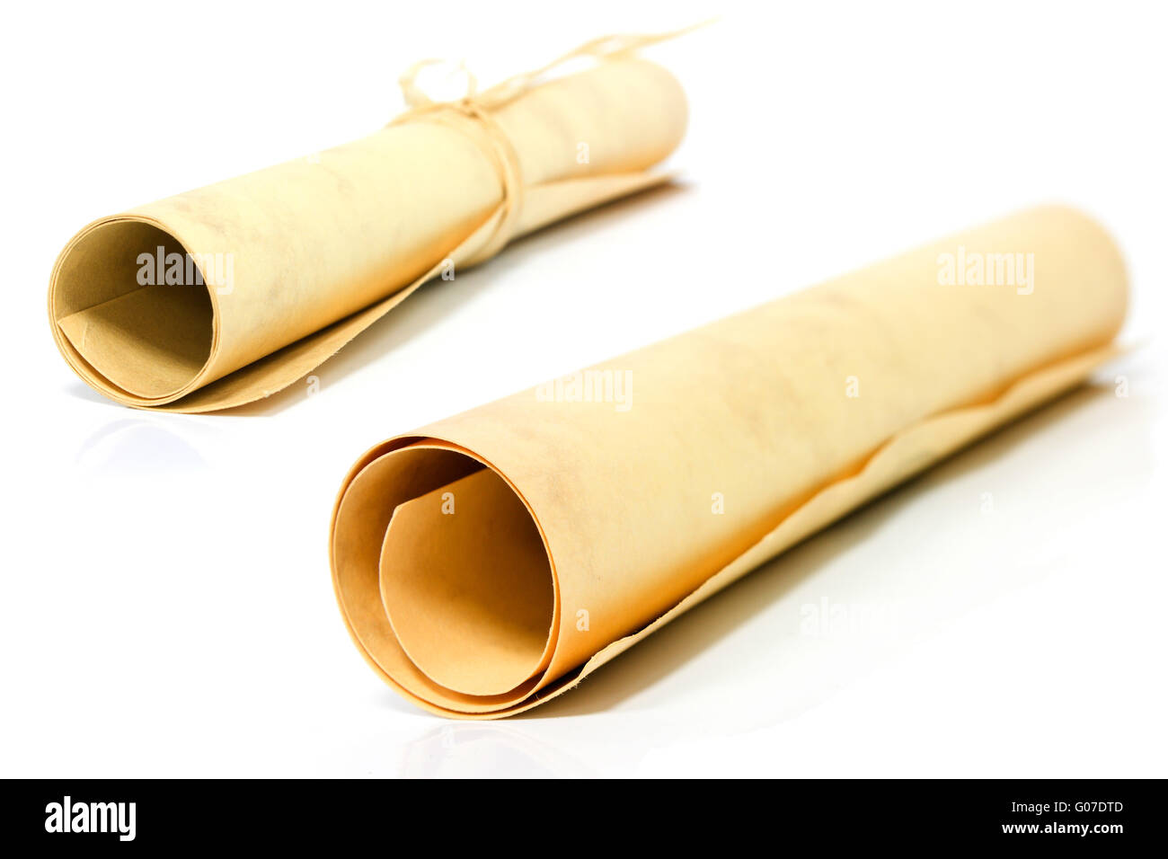 Scroll of old paper diplom isolated over white Stock Photo