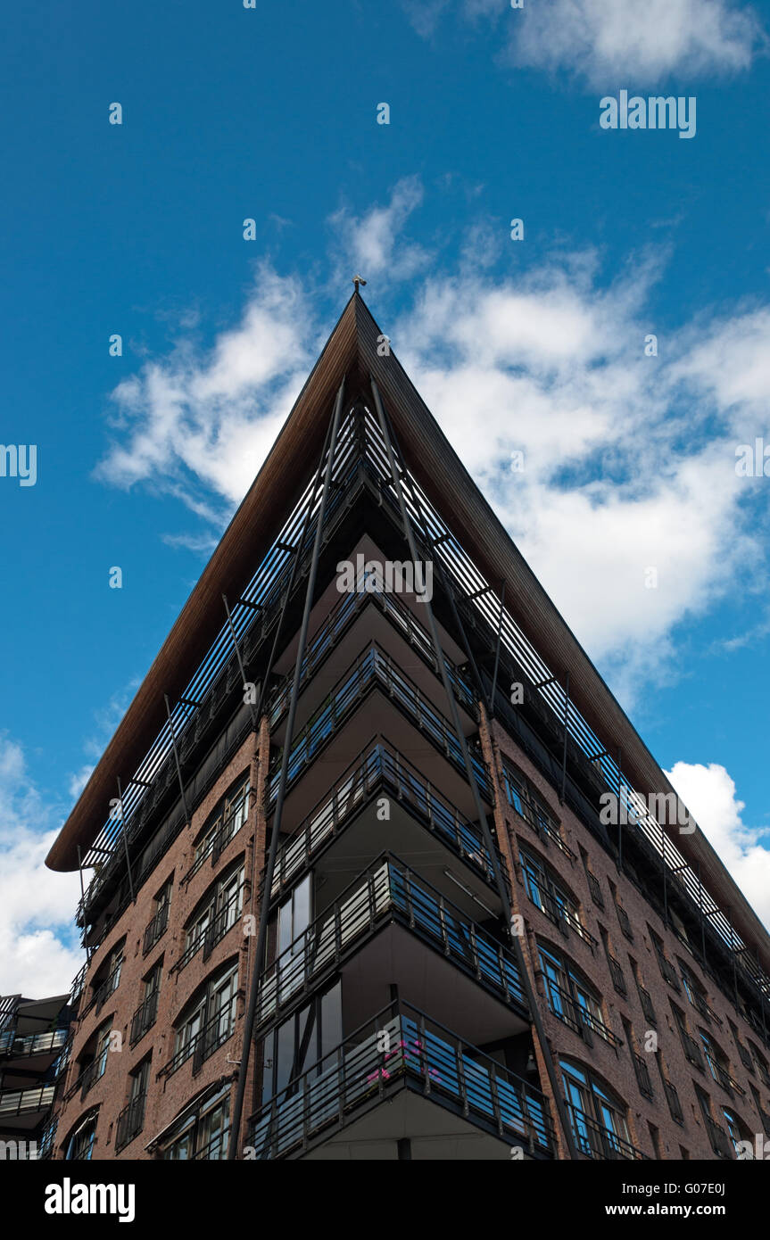 Tall building with angled roof against the blue sky Stock Photo
