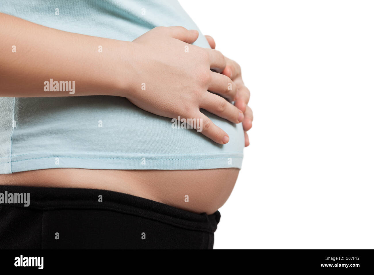 Pregnant woman touching or bonding her abdomen Stock Photo