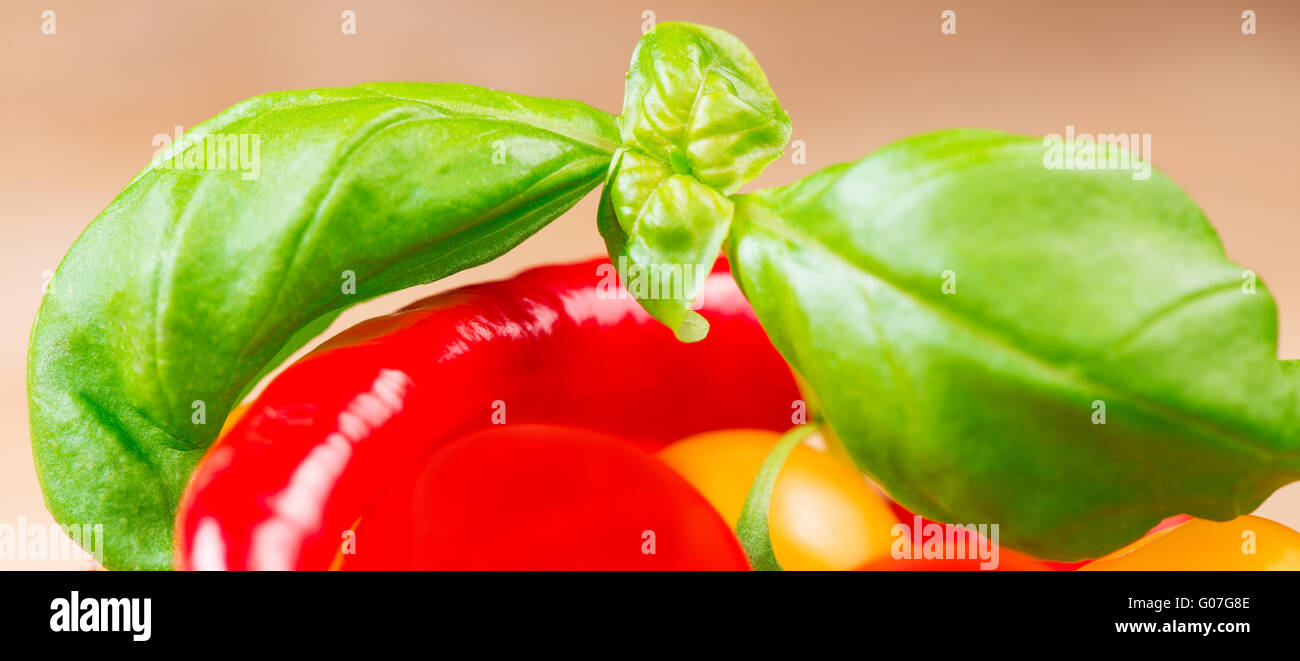 basil leafs with cherry tomatoes and chili pepper close up Stock Photo