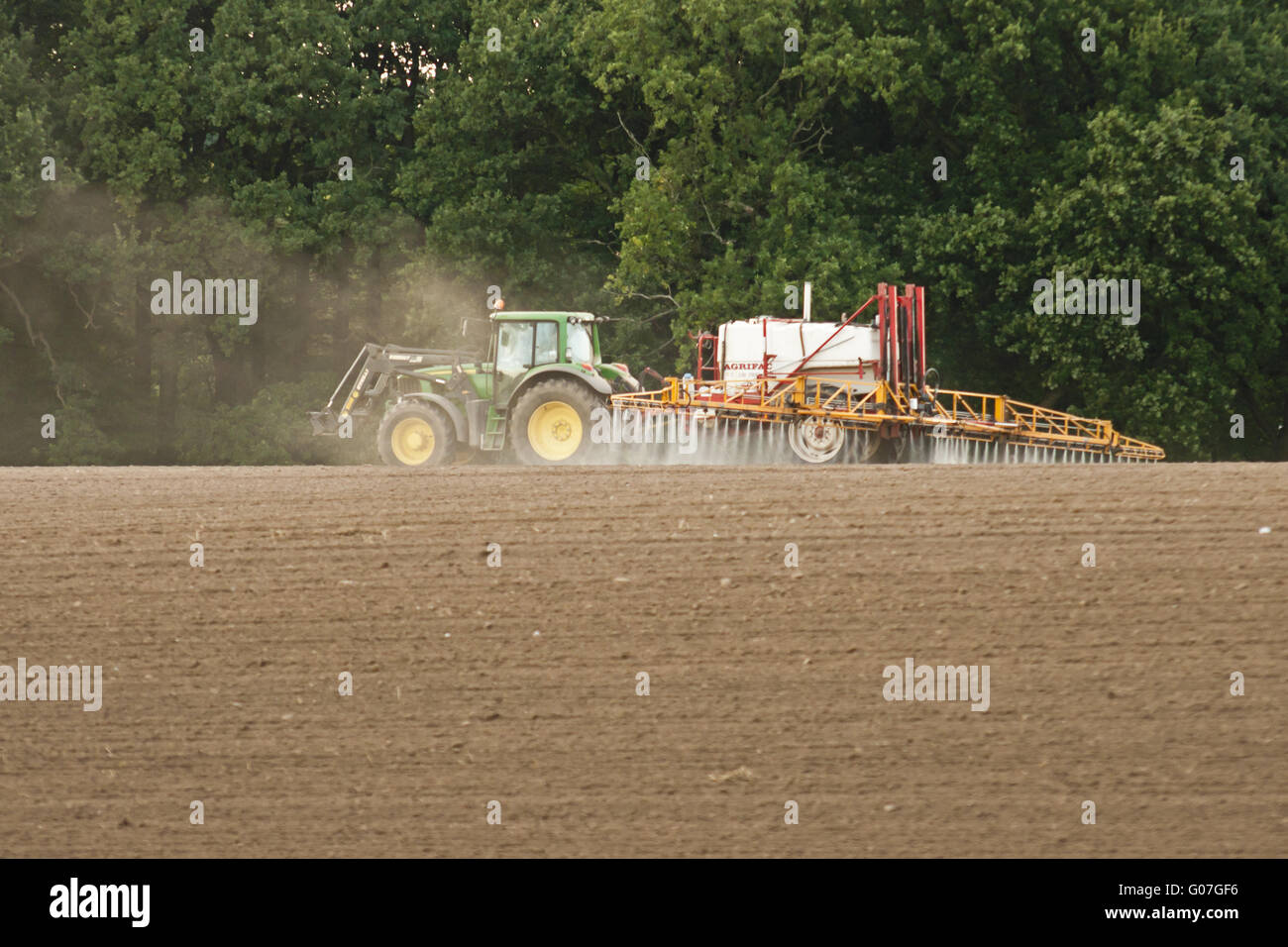 Spraying on fields Stock Photo