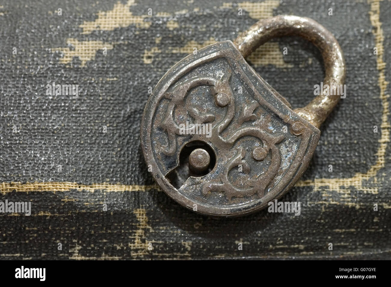 The old lock isolated on a leather background Stock Photo - Alamy
