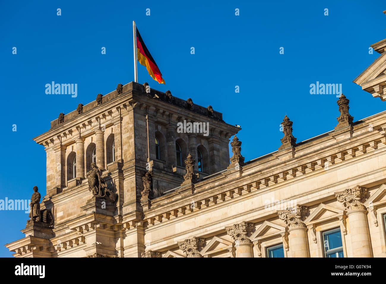 The German Federal Parliament (Reichstag) building in Berlin, with German flags Stock Photo