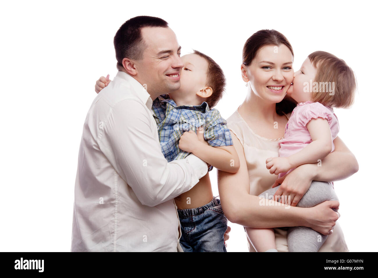 Happy young family with pretty child posing on white background Stock Photo