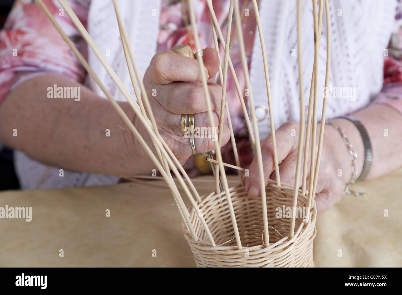 Hands of a novel senior citizen making baskets Stock Photo