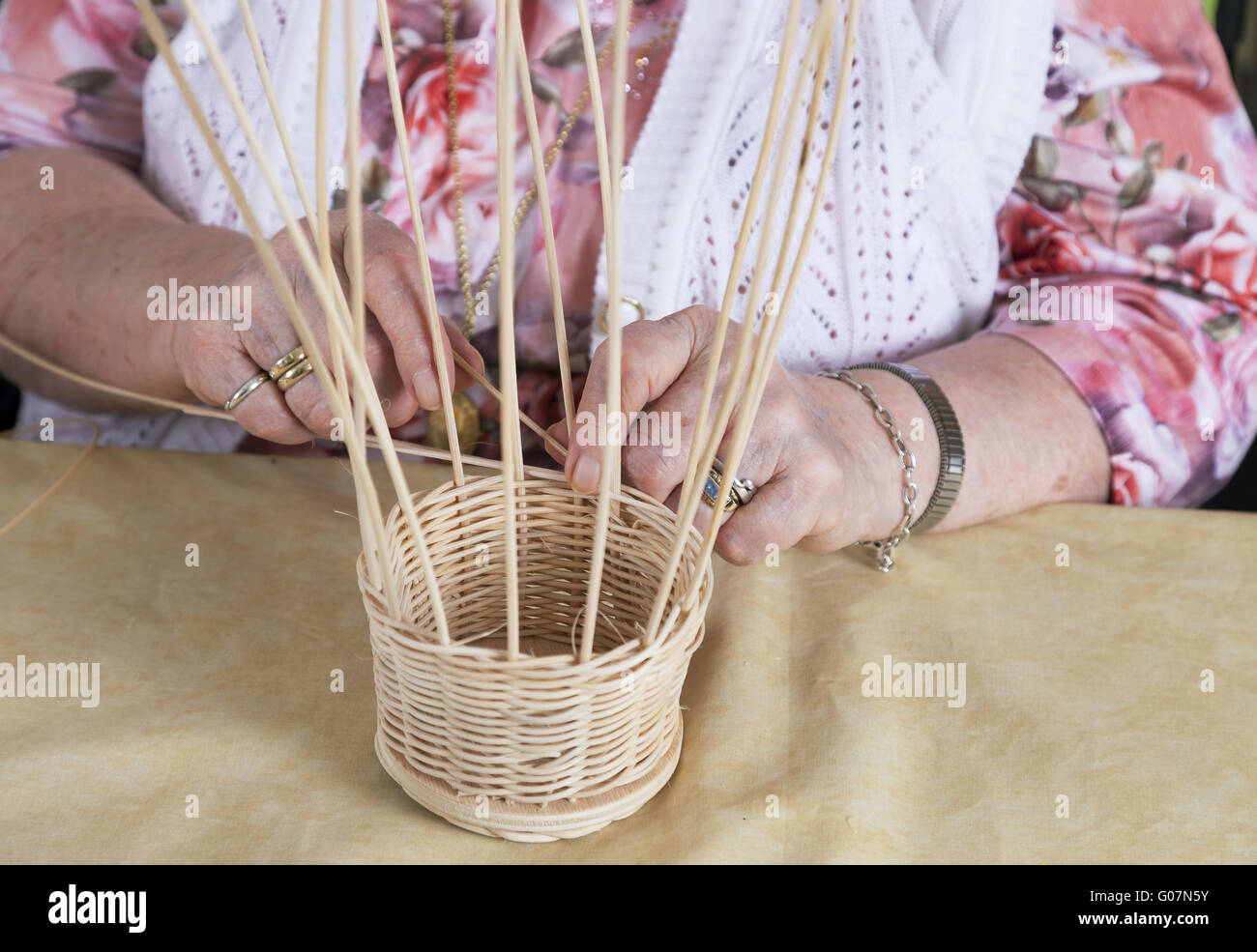 Hands of a novel senior citizen making baskets Stock Photo