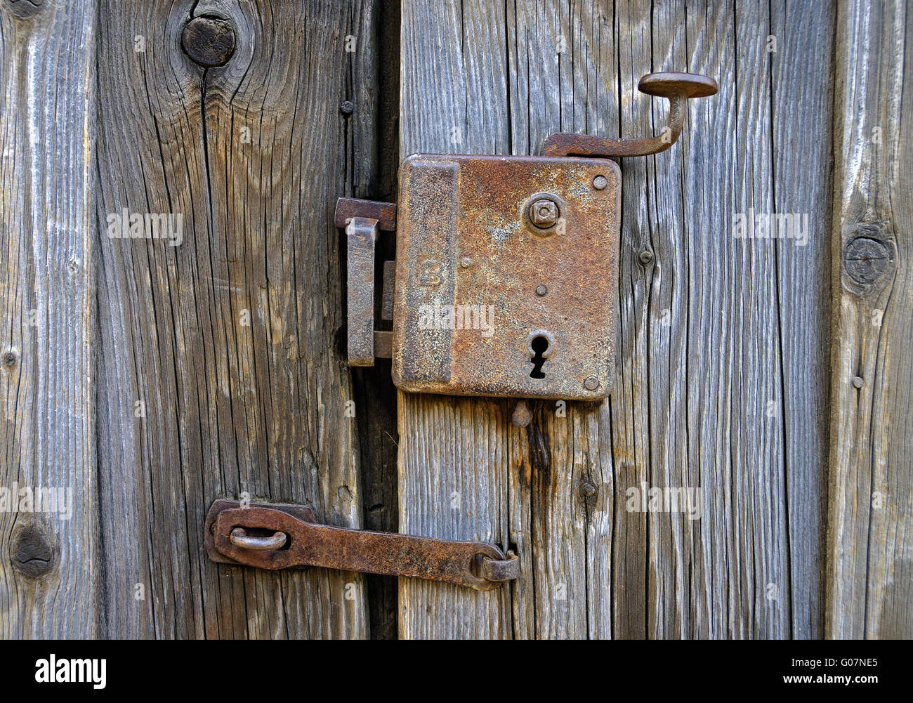old and rusty lock on an old wooden barn door Stock Photo
