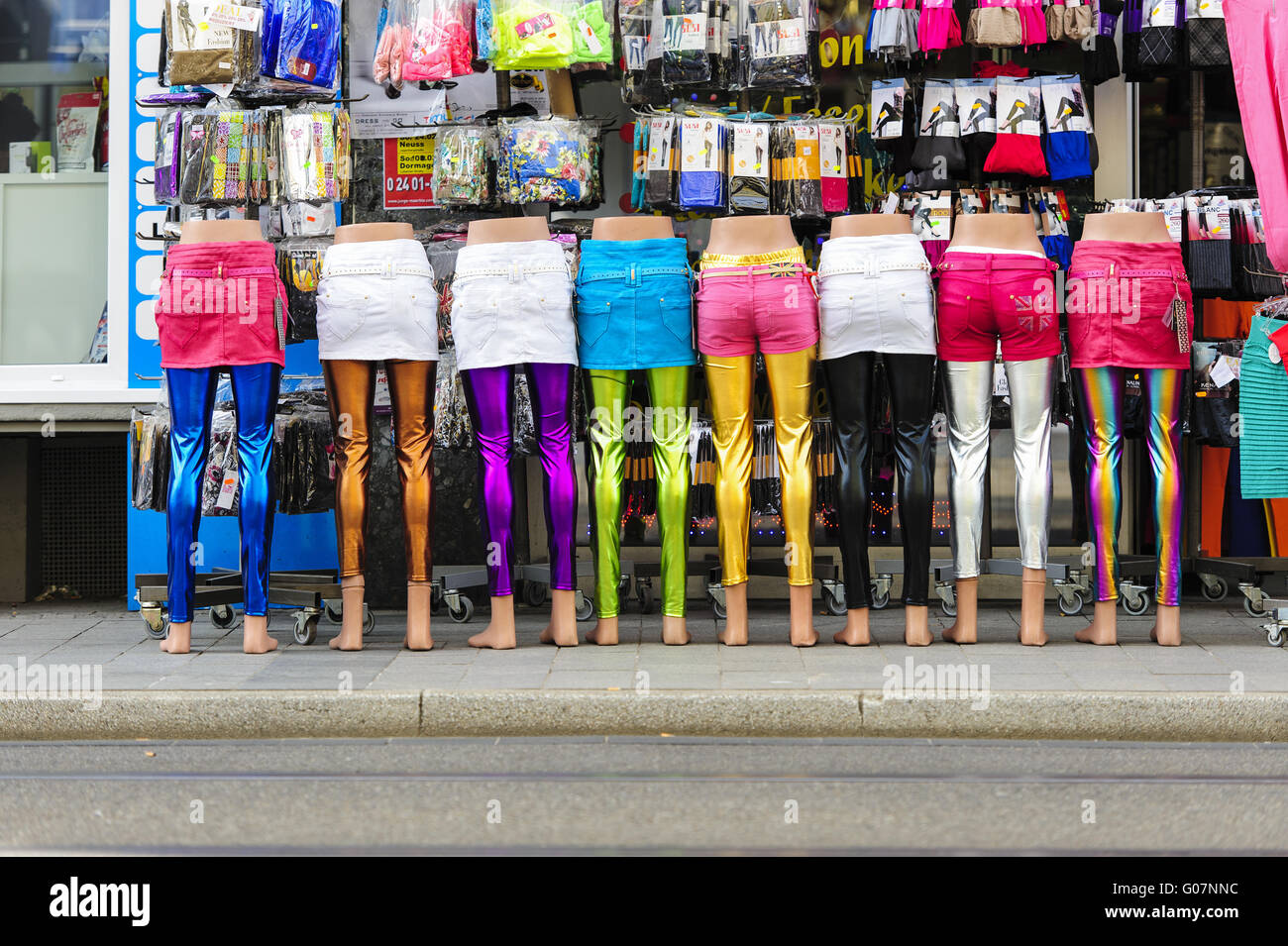 Mannequins standing in row in front of a clothing Stock Photo