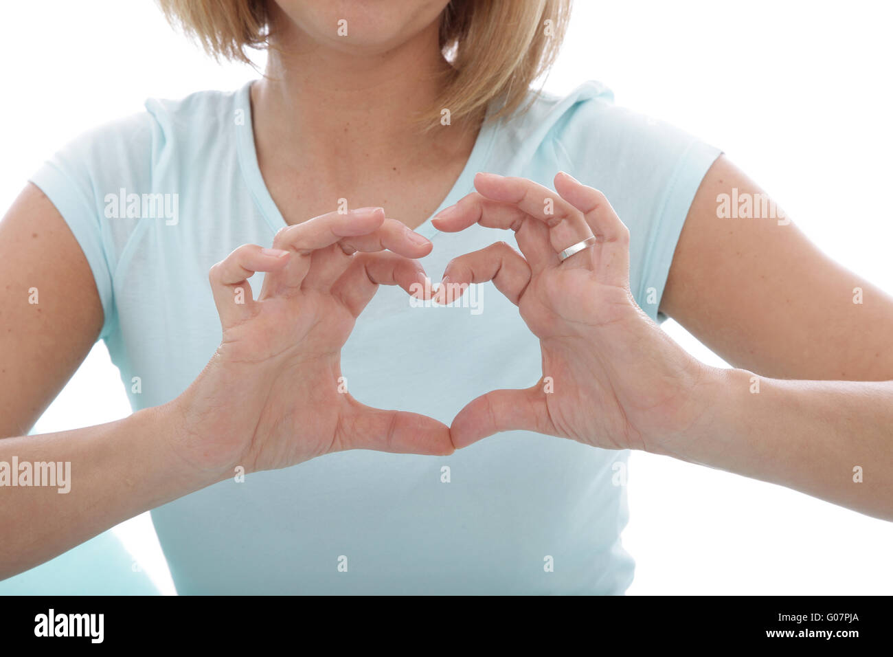 Woman making a heart gesture with her fingers Stock Photo