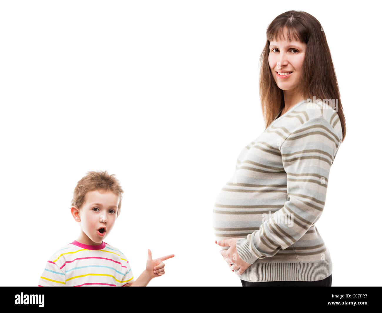 Child boy pointing his pregnant mother abdomen Stock Photo
