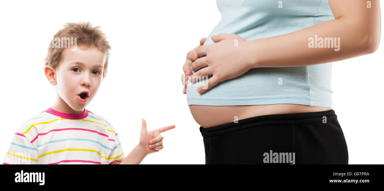 Child boy pointing his pregnant mother abdomen Stock Photo