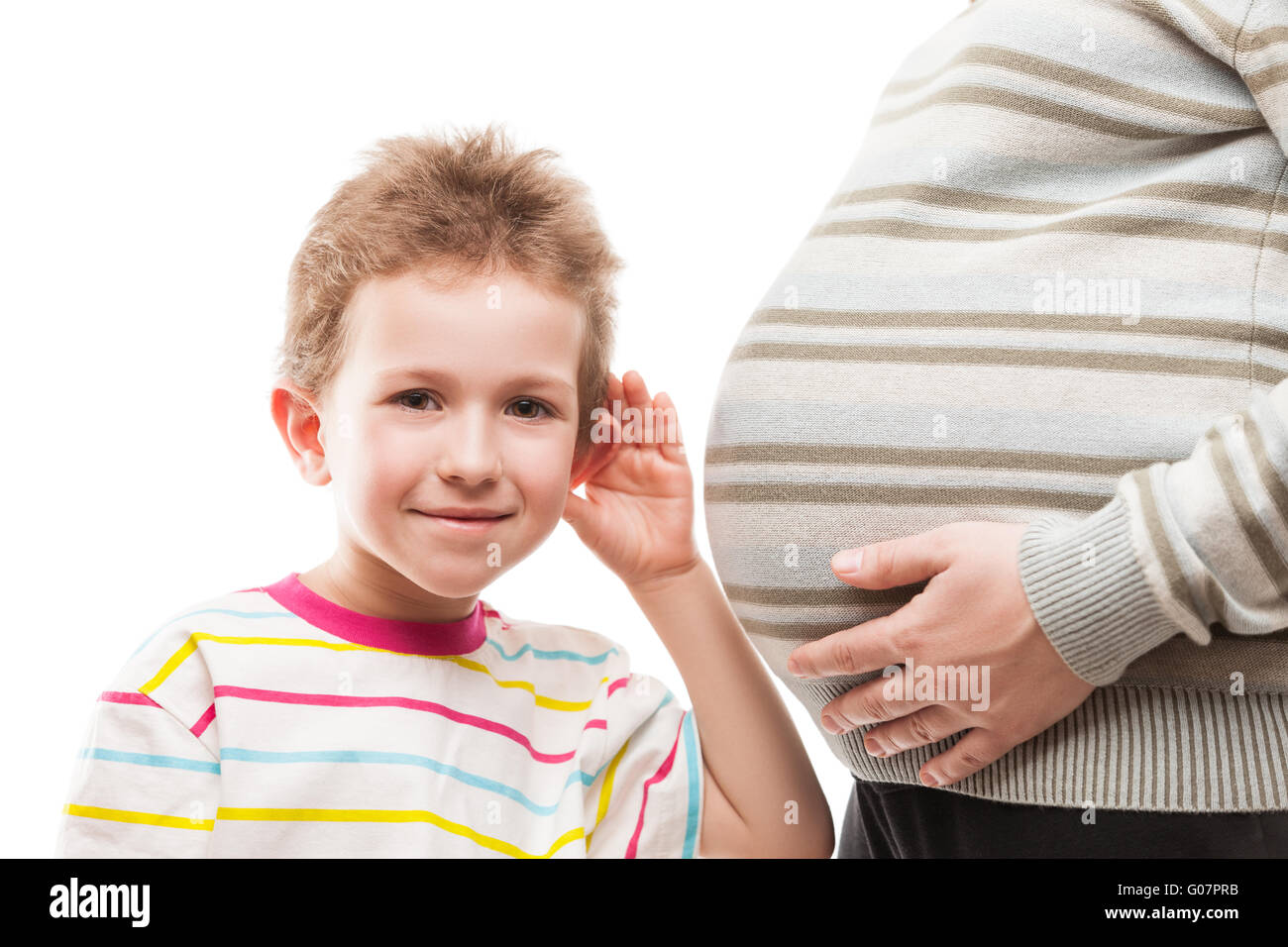 Curious child boy listening his pregnant mother ab Stock Photo