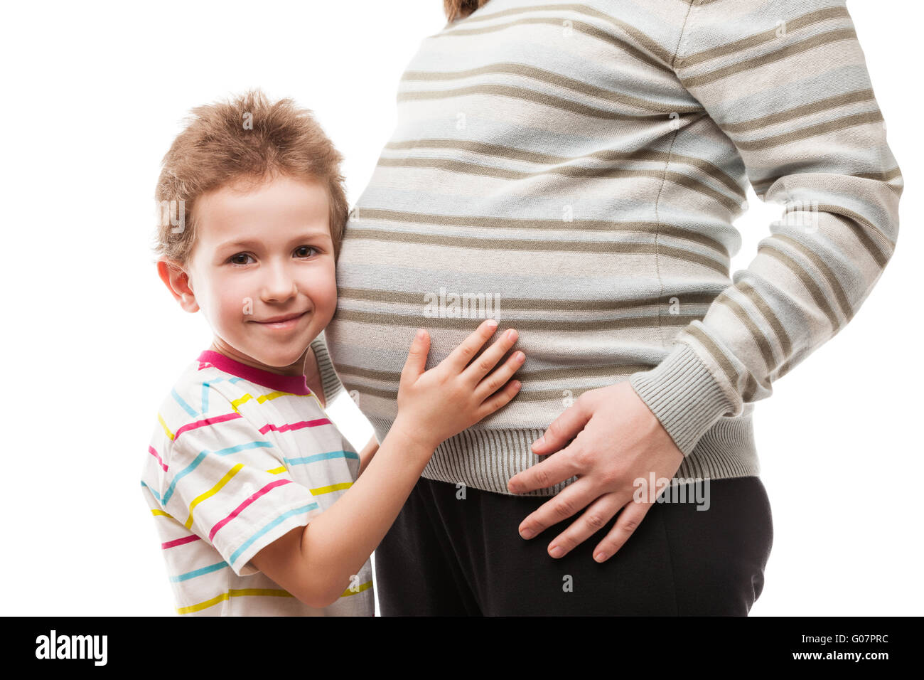 Little son touching or bonding his pregnant mother Stock Photo