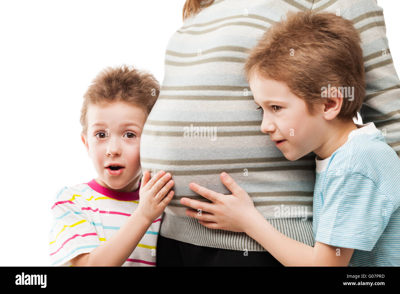 Two little sons touching or bonding their pregnant Stock Photo