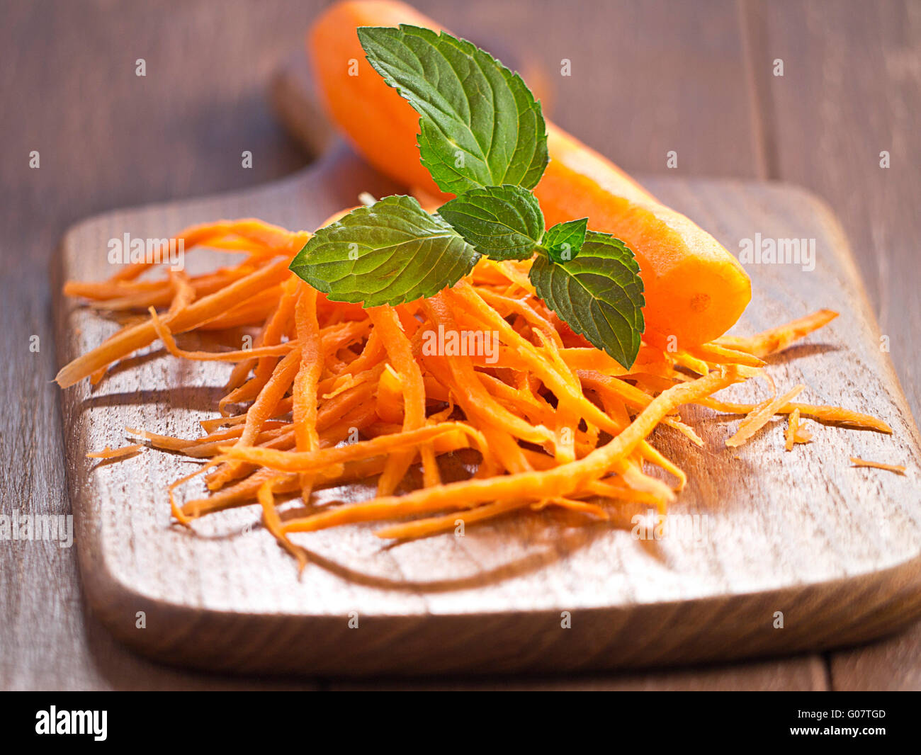 Carrots Julienne with a carrot on a wooden tray Stock Photo