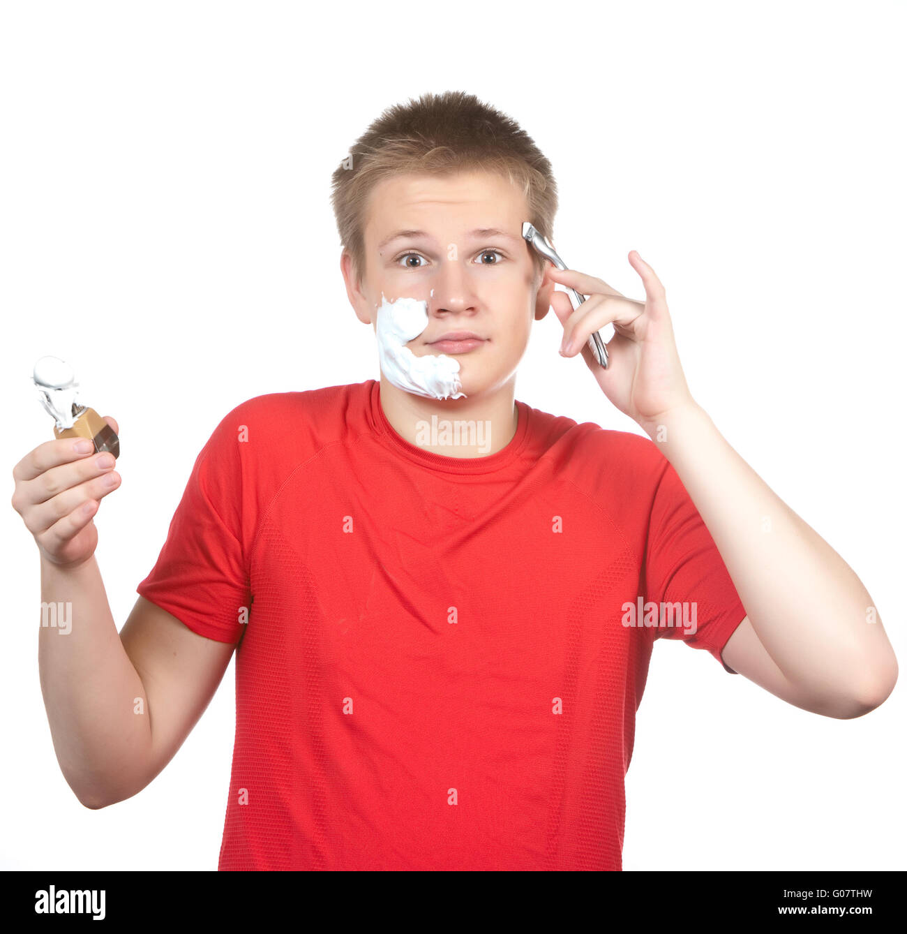 the teenager the first time tries to have a shave Stock Photo