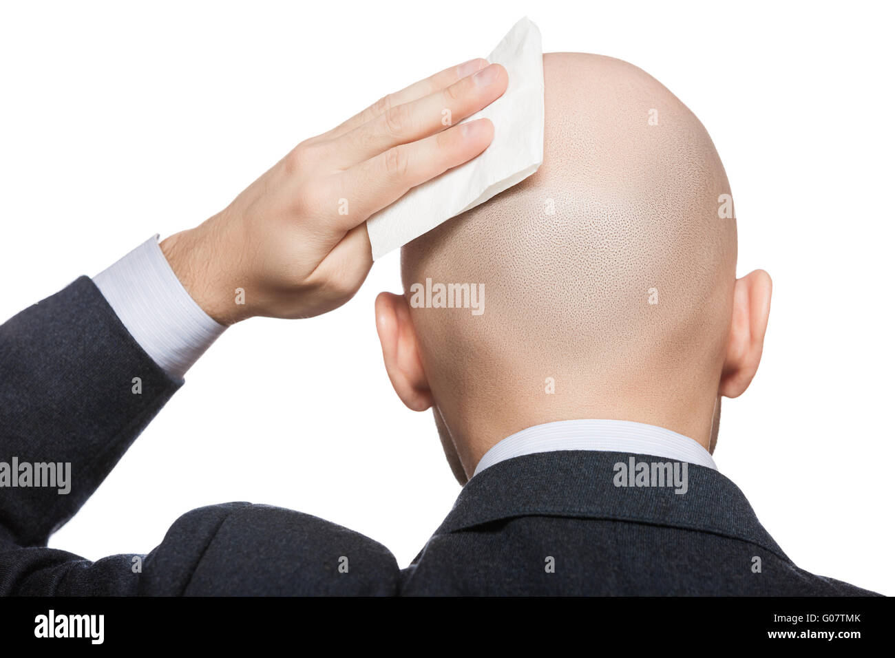 Hand holding tissue wiping or drying bald sweat he Stock Photo