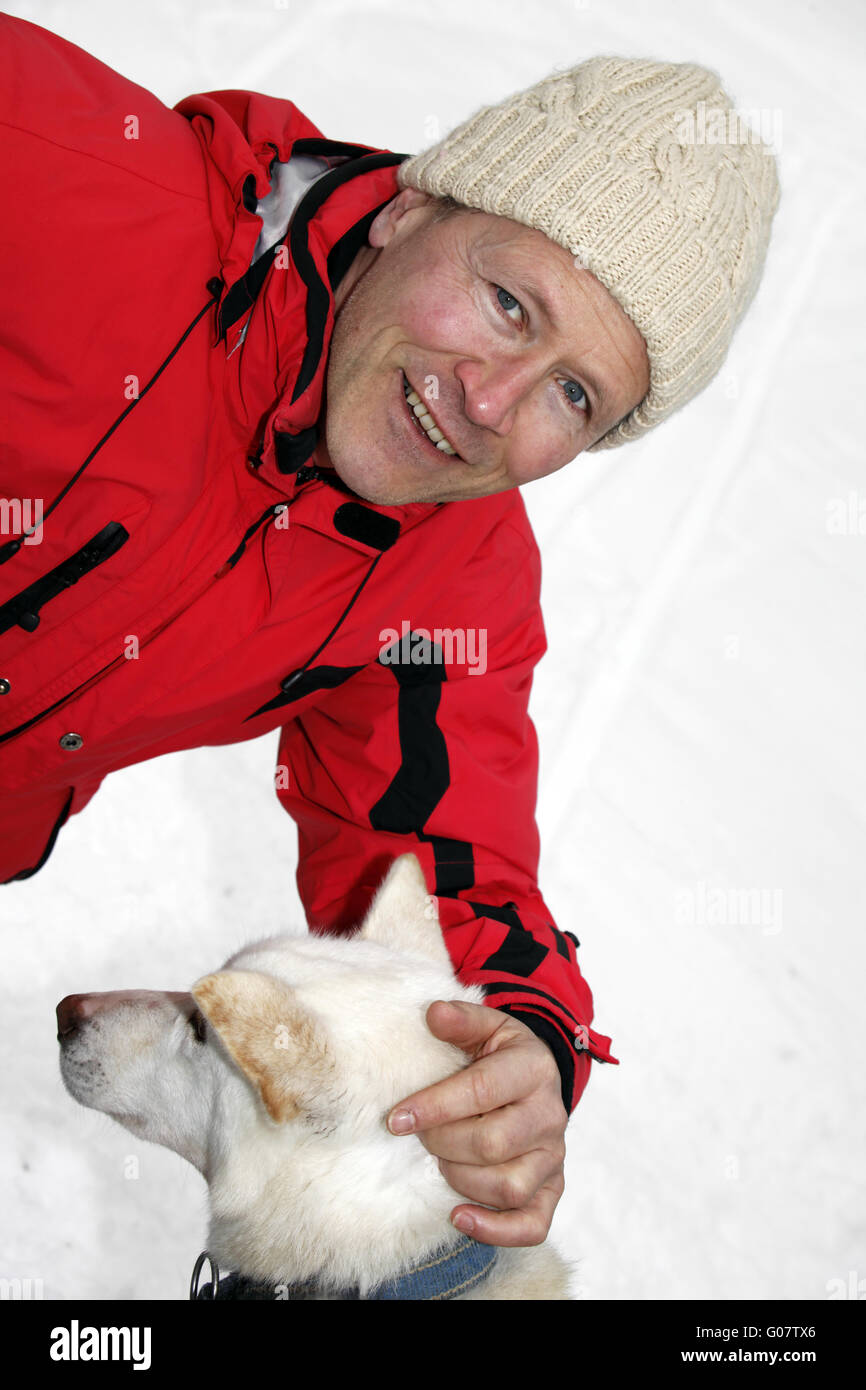 Man cuddling up with a Siberian Husky Stock Photo