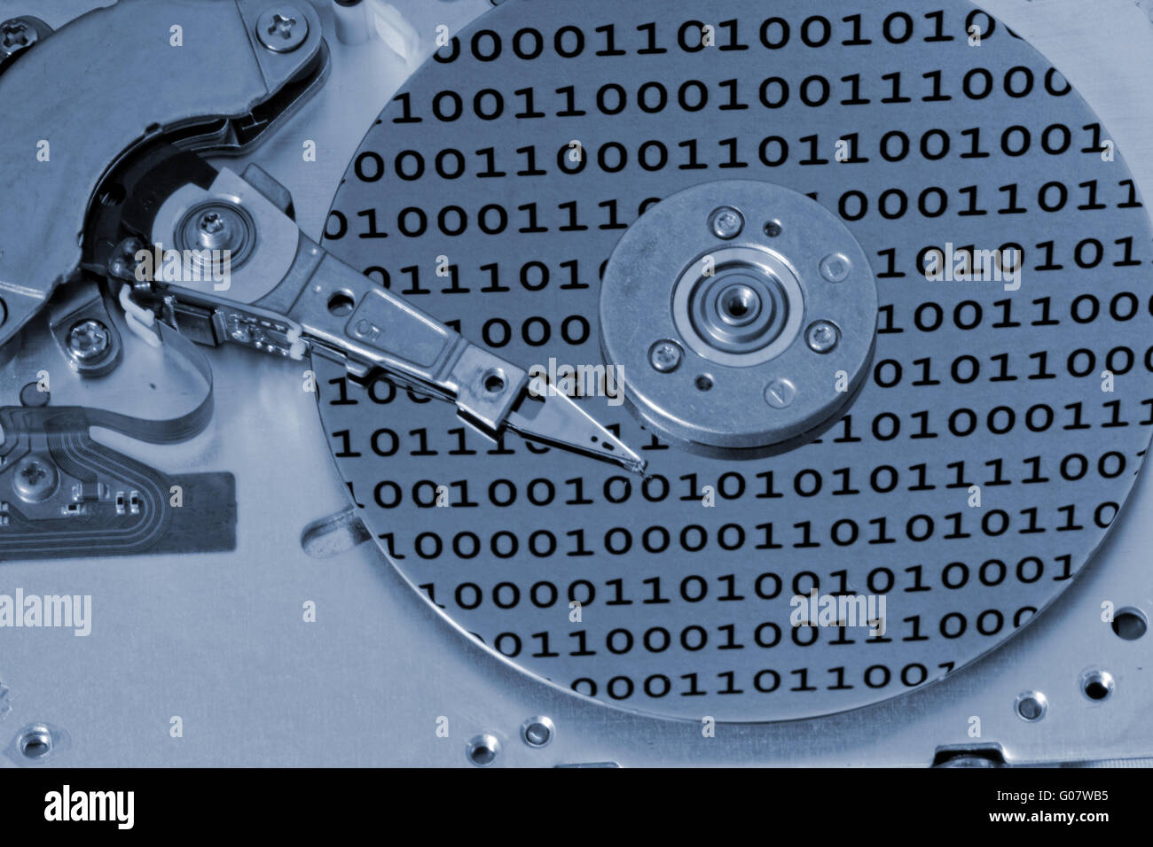 Internals of a computer harddrive with binary number reflections with blue colors (HDD Stock Photo