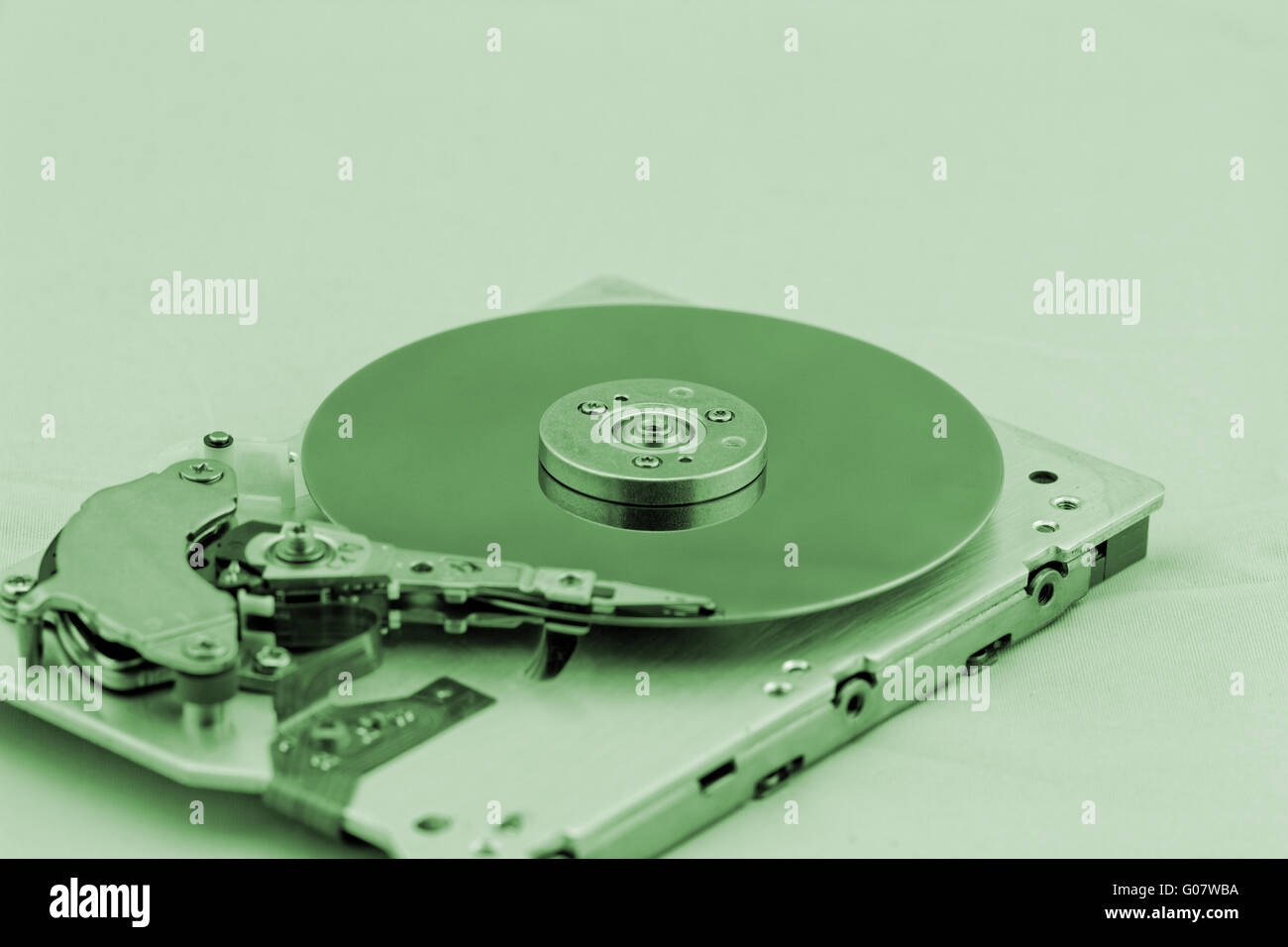 Open computer hard drive on white background with green (HDD Stock Photo