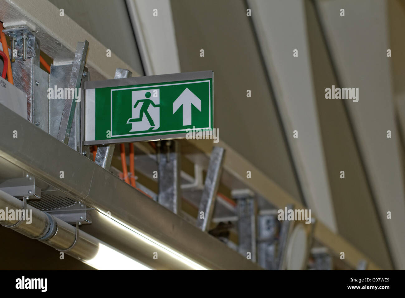 Emergency exit sign in construction site an industrial plant Stock