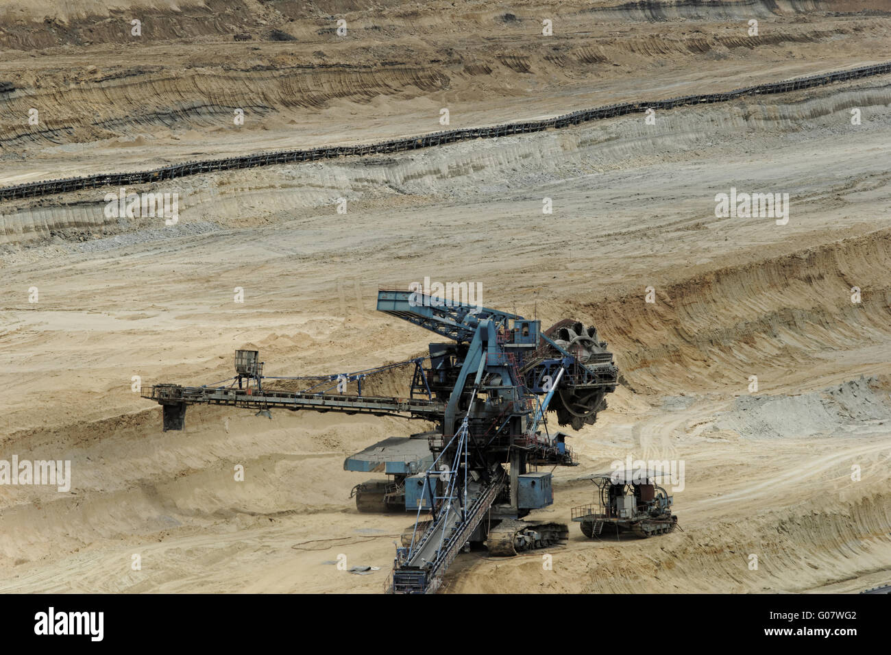 Coal mining in an open pit with huge industrial machine Stock Photo