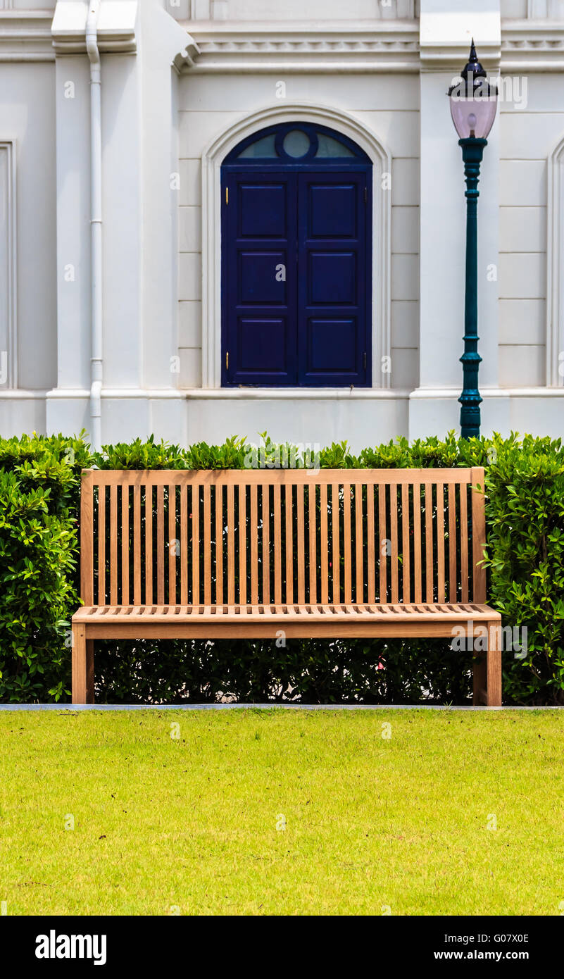 Wooden Bench in front of White Building and Street Stock Photo - Alamy