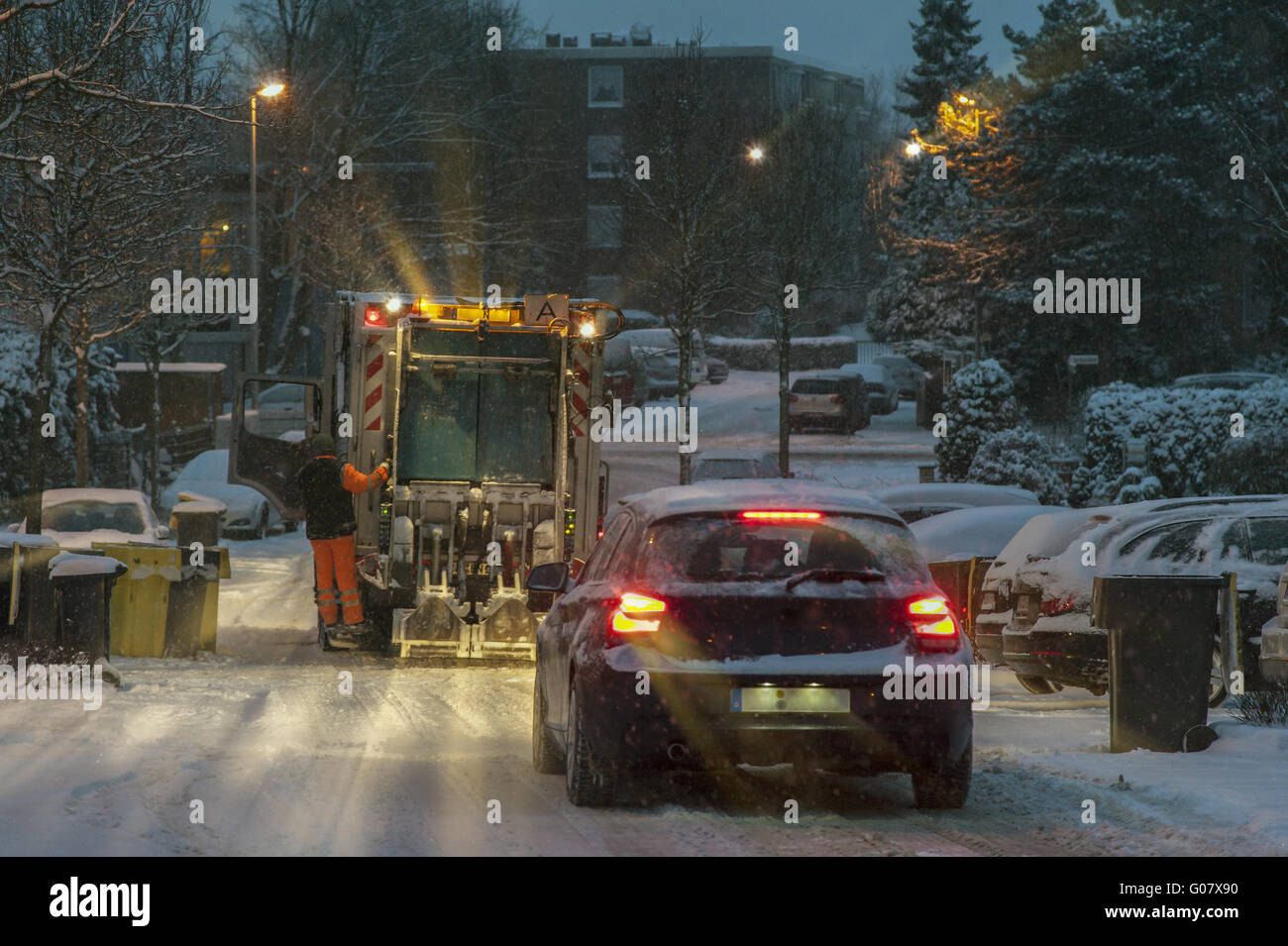 Cars and garbage disposal on a winter morning in a Stock Photo
