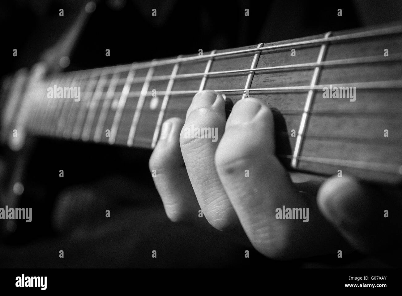 Fingers strumming guitar hires stock photography