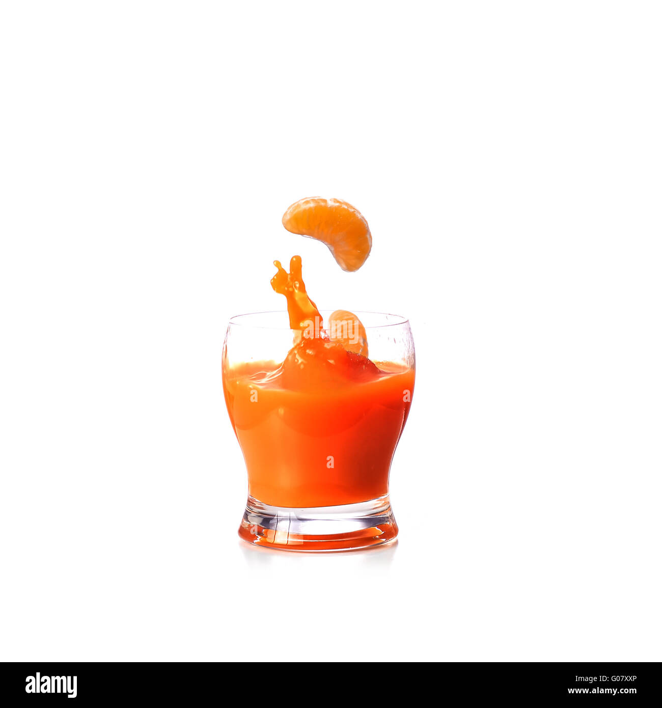 Mandarins falling in glass of juice Stock Photo Alamy