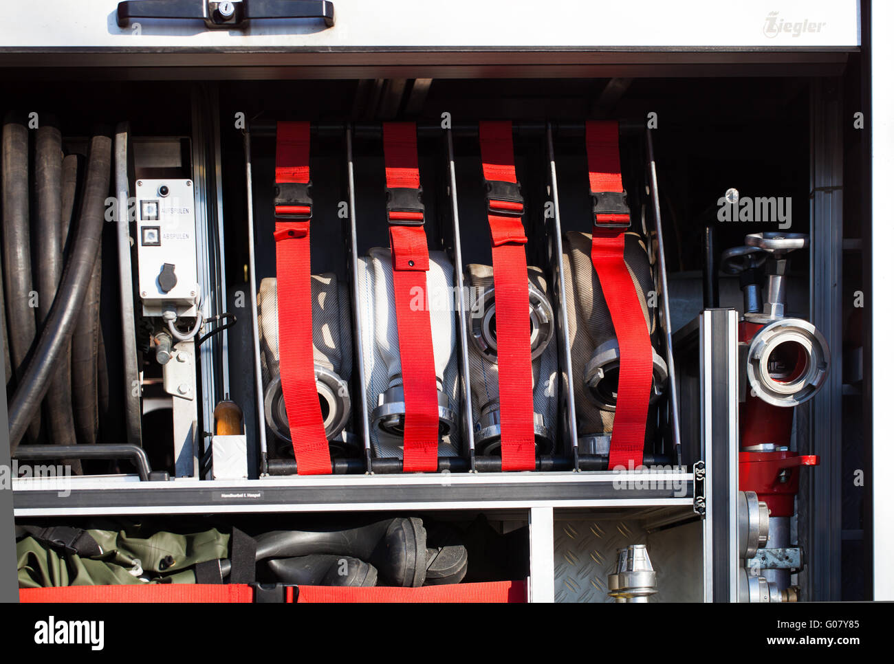 Firefighters sidewall open one emergency vehicle Stock Photo