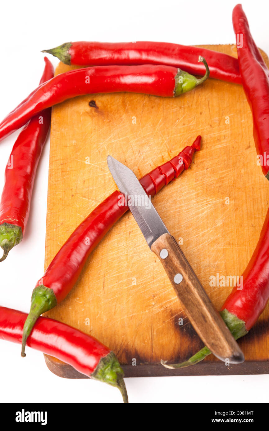 hot capsicum chili pepper and knife on board Stock Photo Alamy