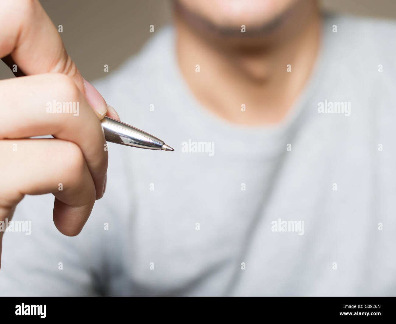 Man holding pen, writing and drawing in the air with copy space Stock