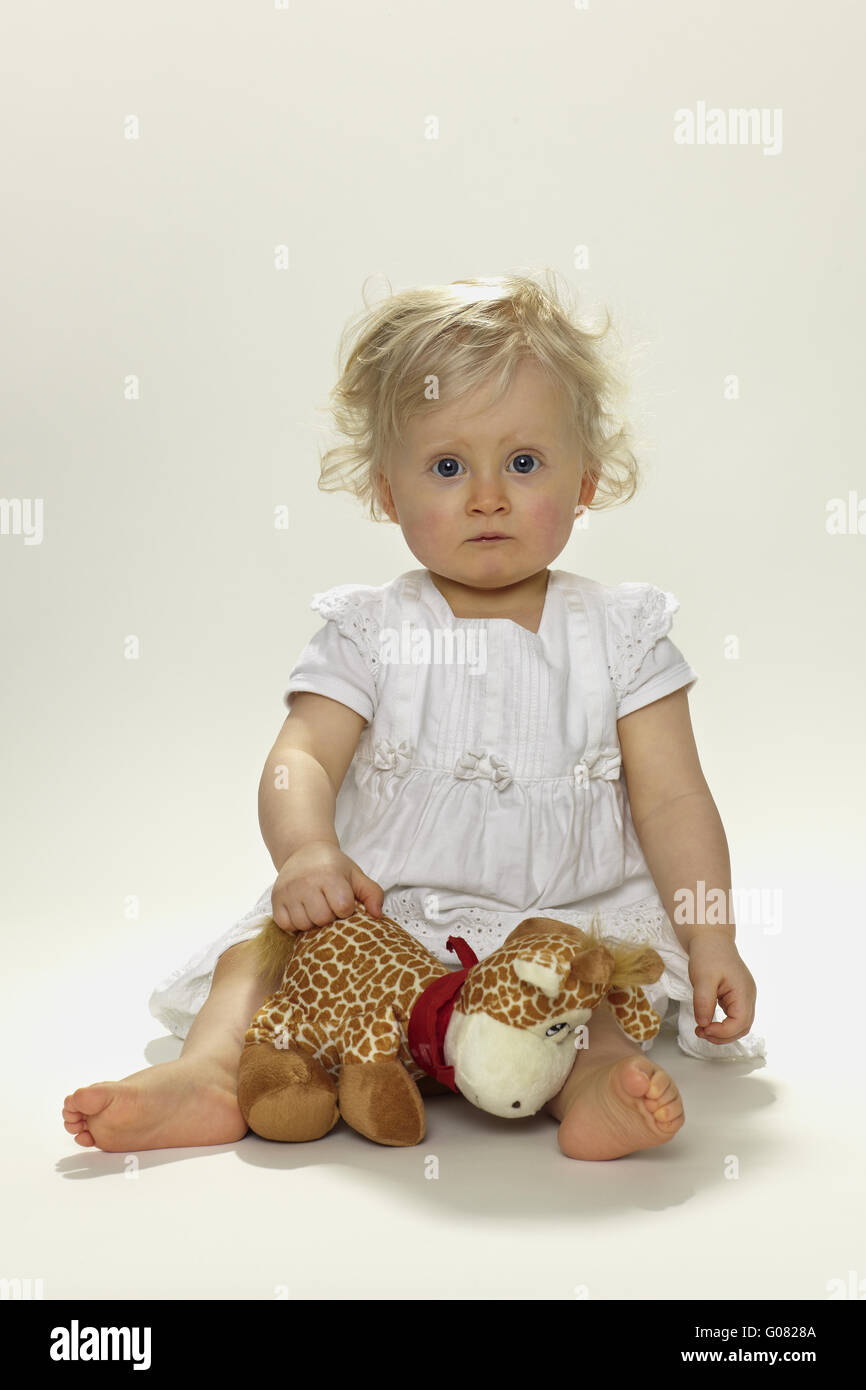 Little girl with stuffed animal Stock Photo - Alamy