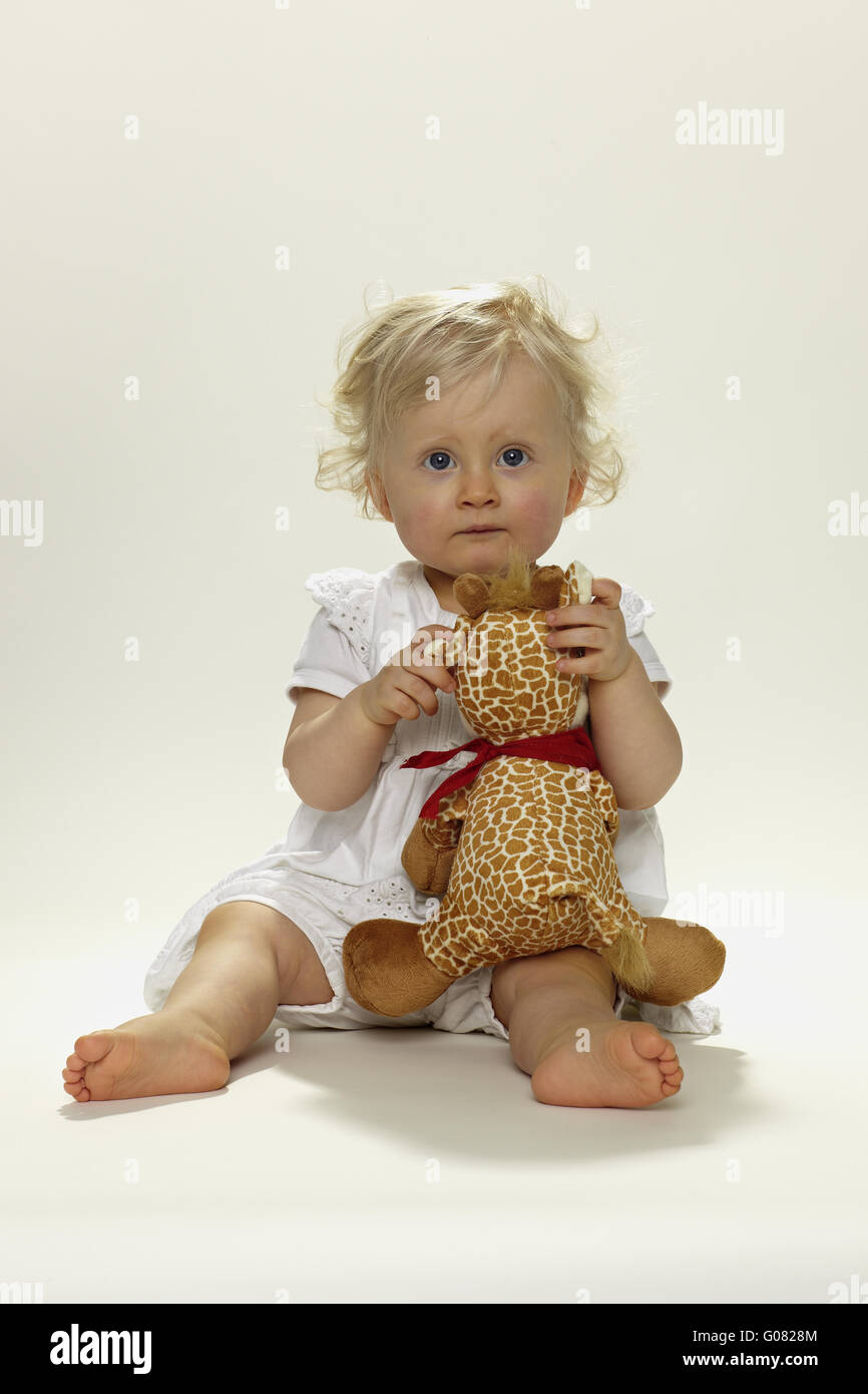 Little girl with stuffed animal Stock Photo - Alamy