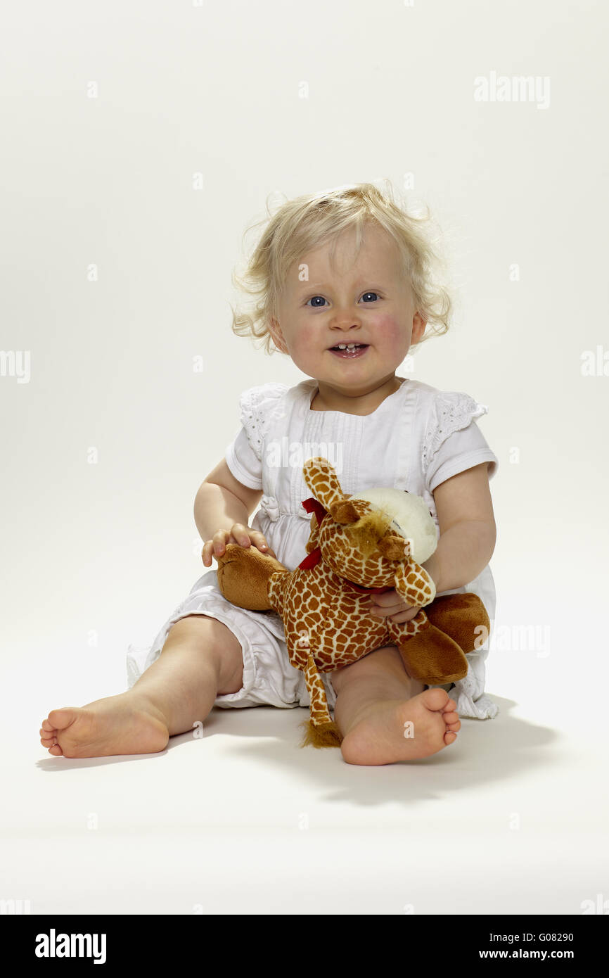 Little girl with stuffed animal Stock Photo - Alamy