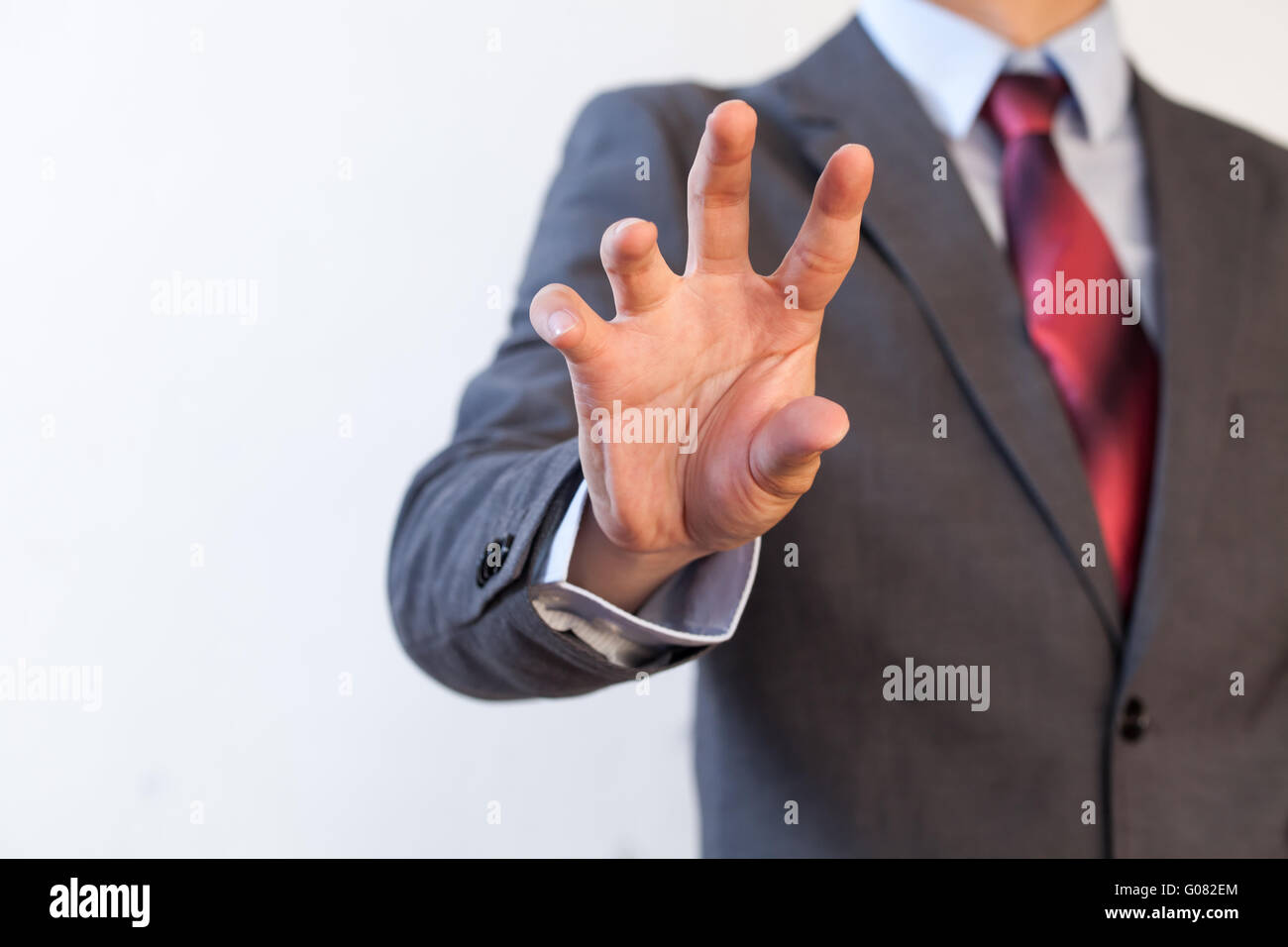 Businessman pinching in the air with five fingers - Digital and imagination concept Stock Photo