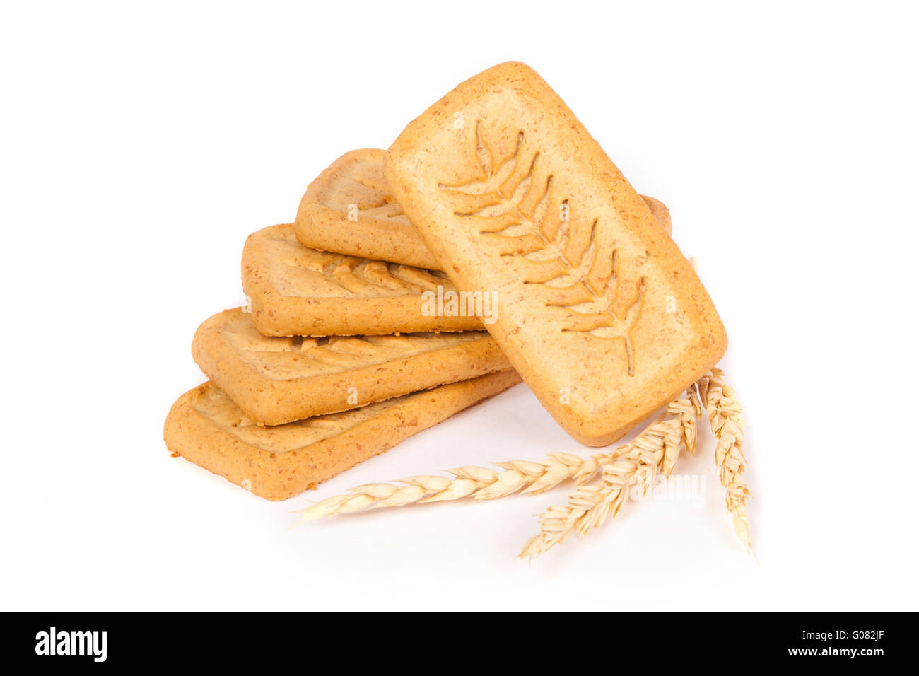 pile of pastry cookies with wheat isolated on whit Stock Photo