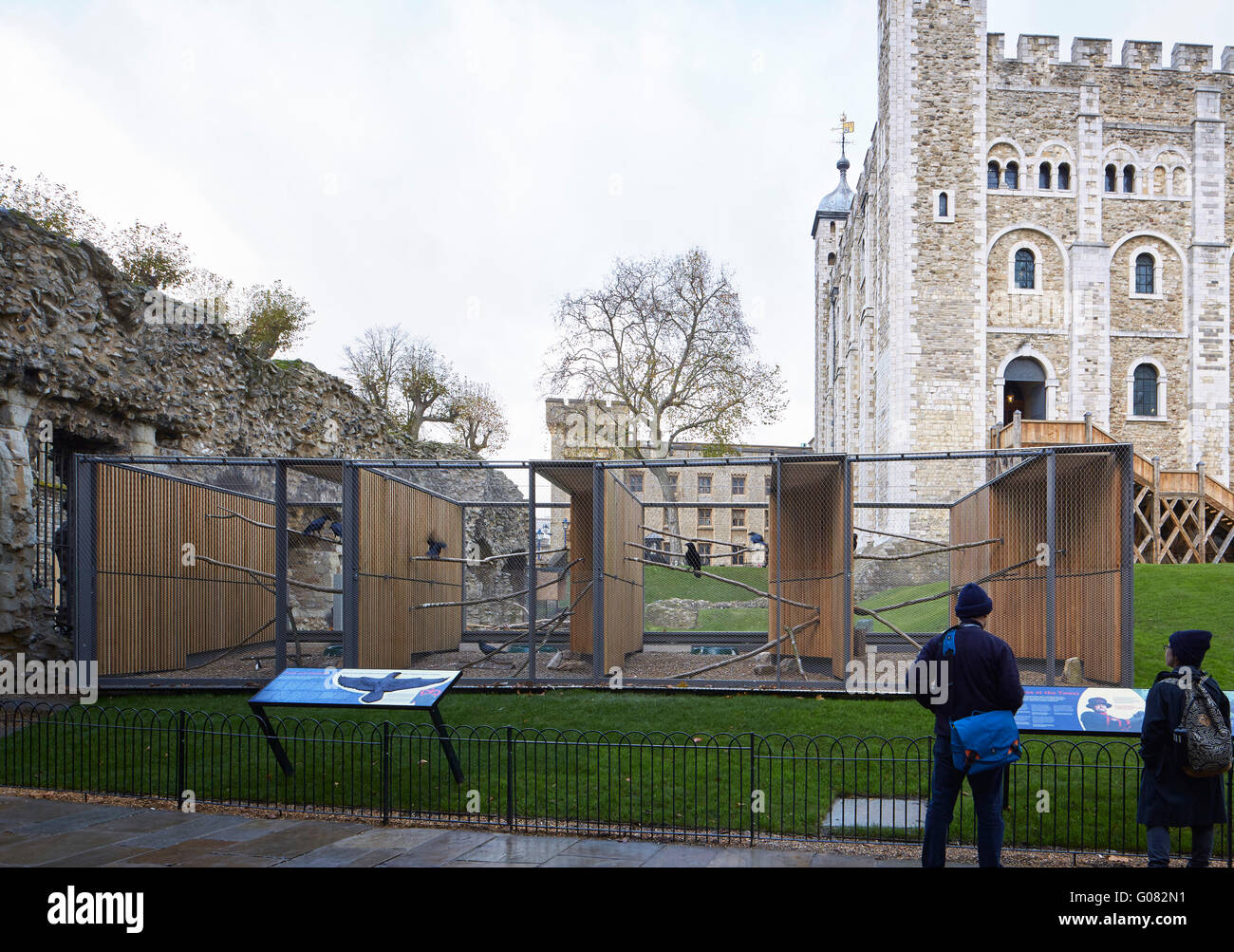Low level view from tower wall with Tower of London in background. Ravens Night Enclosures at Tower of London, London, United Kingdom. Architect: llowarch and llowarch architects, 2015. Stock Photo