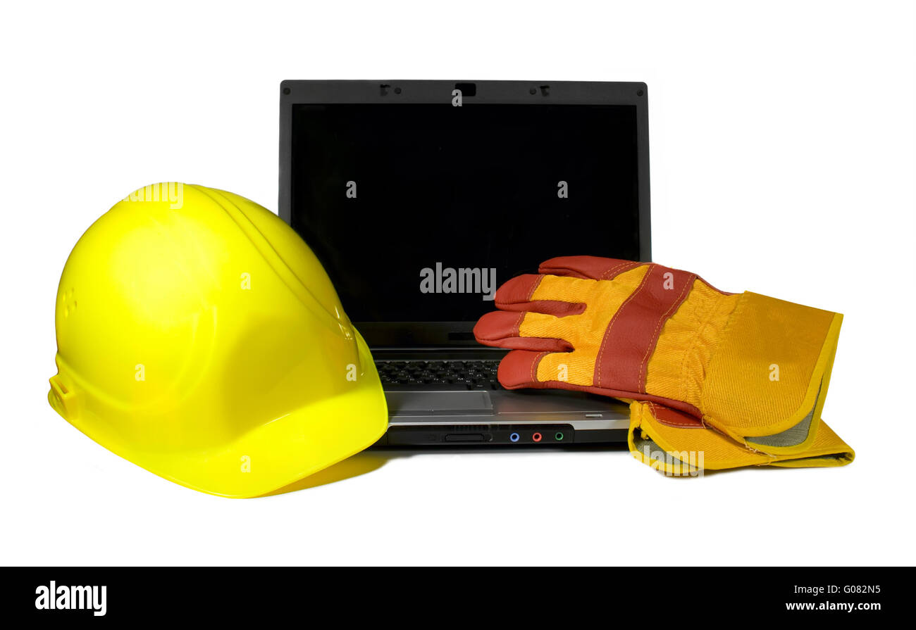 Yellow Hard Hat and protective gloves on a laptop isolated.Empty black ...