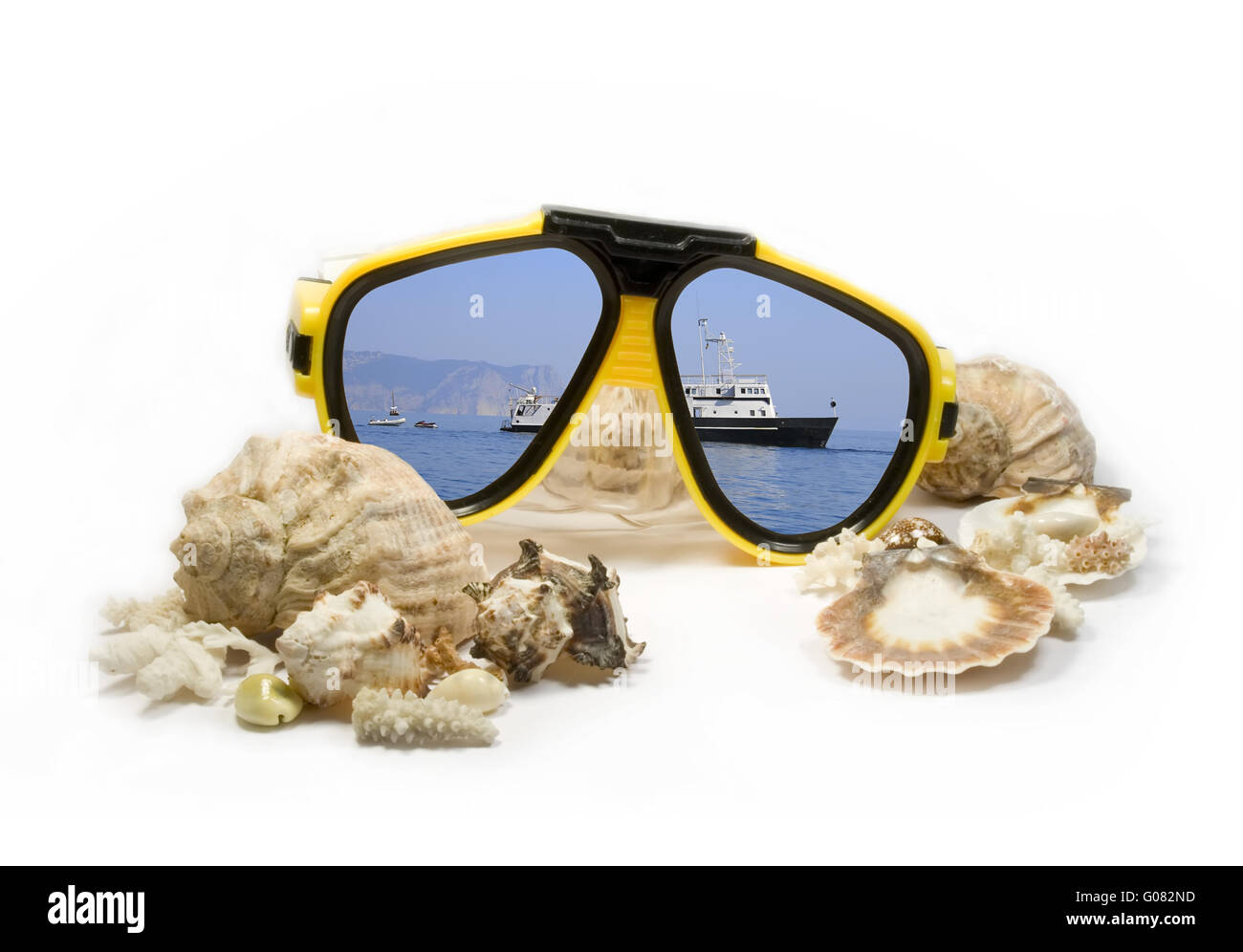 Yellow diving mask with sea shells and sea reflection Stock Photo