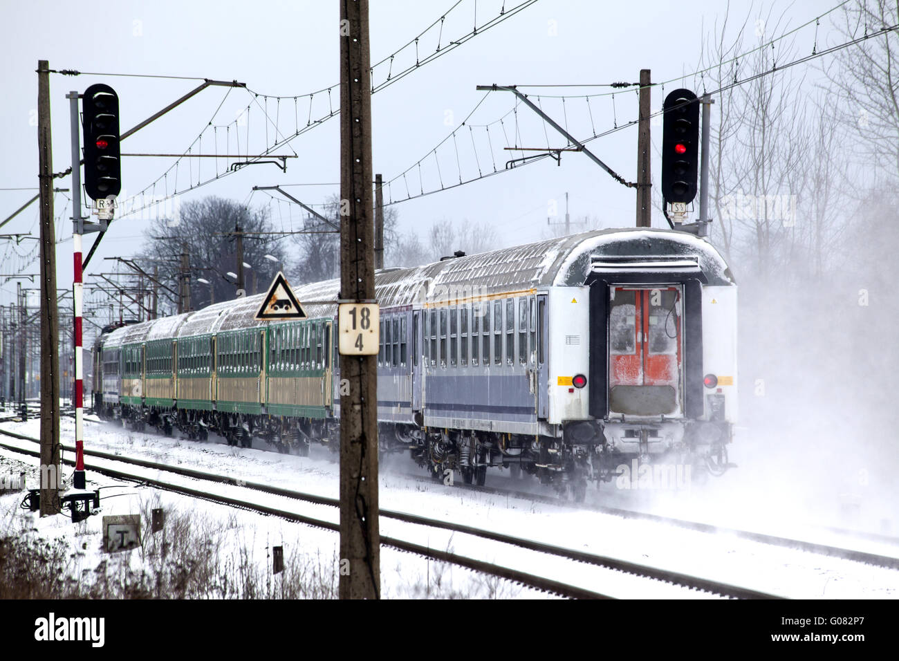 Passenger train passes the snowy line during winte Stock Photo